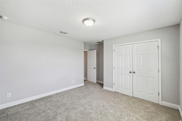 4950 Chase Ct, Saint Cloud, FL 34772 - unfurnished bedroom with carpet flooring, a closet, baseboards, and a textured ceiling