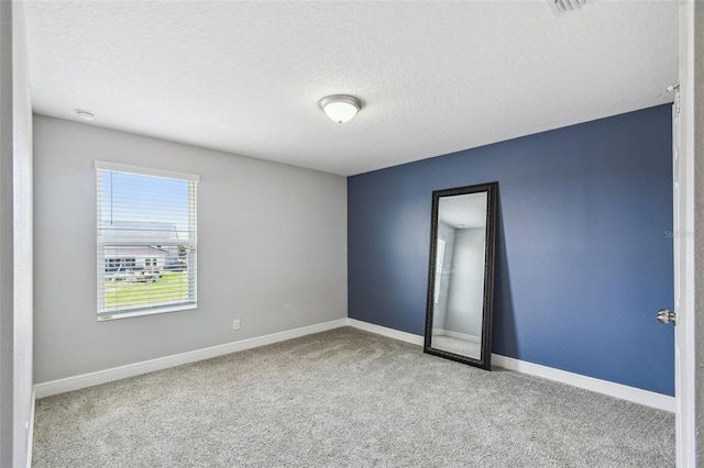 4950 Chase Ct, Saint Cloud, FL 34772 - unfurnished room with carpet floors, a textured ceiling, baseboards, and a smoke detector