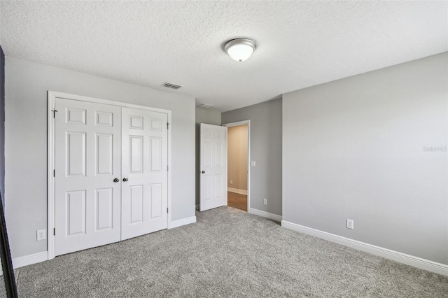 4950 Chase Ct, Saint Cloud, FL 34772 - unfurnished bedroom with carpet, a closet, a textured ceiling, and baseboards