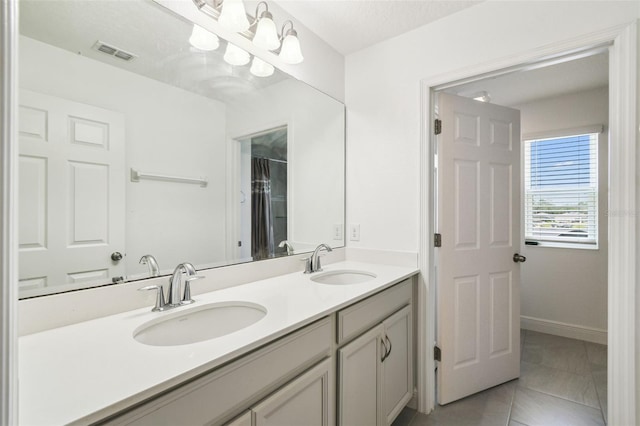 4950 Chase Ct, Saint Cloud, FL 34772 - bathroom featuring double vanity and baseboards