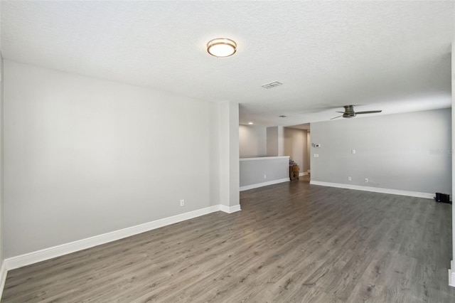 4950 Chase Ct, Saint Cloud, FL 34772 - unfurnished room with wood finished floors, ceiling fan, baseboards, and a textured ceiling