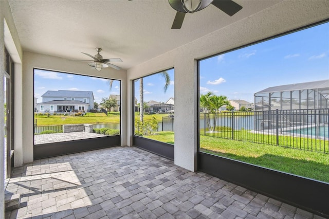 4950 Chase Ct, Saint Cloud, FL 34772 - unfurnished sunroom with ceiling fan, a water view, and a residential view
