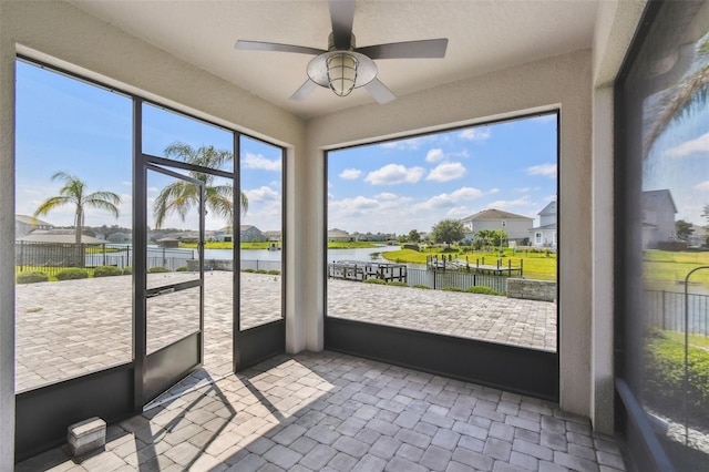 4950 Chase Ct, Saint Cloud, FL 34772 - unfurnished sunroom with a water view, a ceiling fan, and a residential view