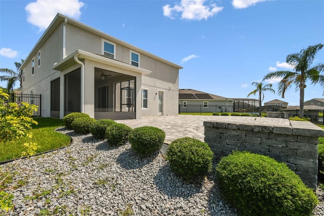 4950 Chase Ct, Saint Cloud, FL 34772 - rear view of house with a sunroom, stucco siding, a patio area, and ceiling fan