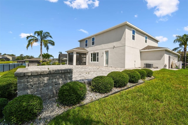 4950 Chase Ct, Saint Cloud, FL 34772 - rear view of property featuring stucco siding, a patio, a sunroom, and central AC unit