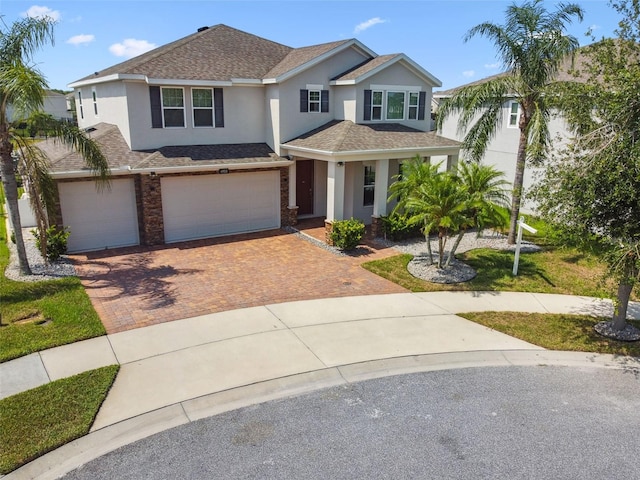 4950 Chase Ct, Saint Cloud, FL 34772 - view of front of property featuring stucco siding, decorative driveway, a garage, roof with shingles, and a porch