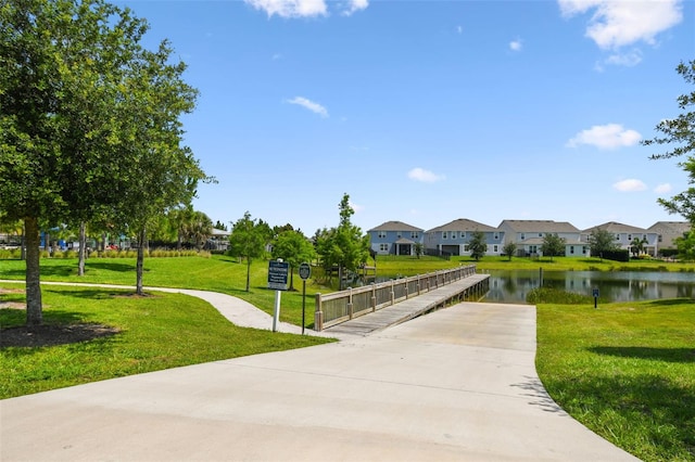 4950 Chase Ct, Saint Cloud, FL 34772 - surrounding community featuring a residential view, a lawn, a water view, and driveway