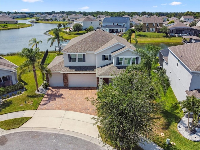 4950 Chase Ct, Saint Cloud, FL 34772 - view of front of home with a residential view, decorative driveway, roof with shingles, stucco siding, and a water view