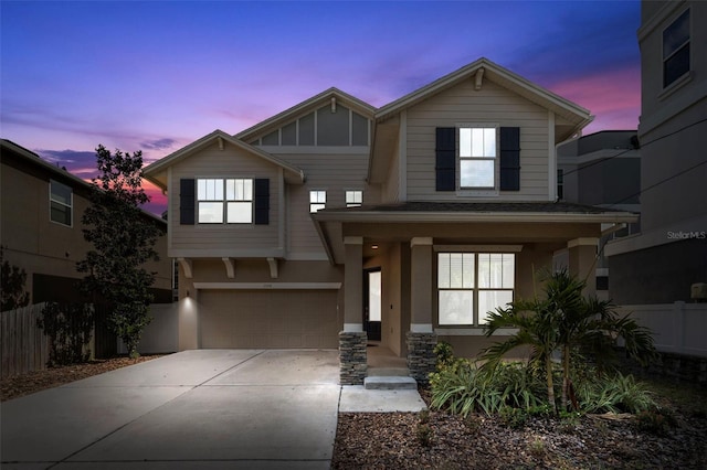 1520 W Fig St, Tampa, FL 33606 - view of front of property with concrete driveway, fence, an attached garage, stucco siding, and covered porch