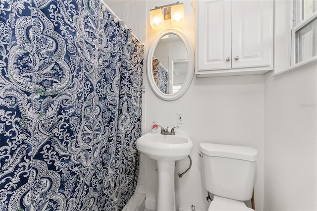 3420 Santa Clara Dr, Punta Gorda, FL 33983 - bathroom featuring toilet, a shower with shower curtain, and a sink
