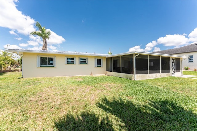 3420 Santa Clara Dr, Punta Gorda, FL 33983 - back of house with a sunroom, a lawn, and stucco siding