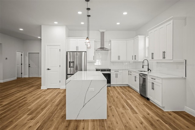 kitchen with appliances with stainless steel finishes, a center island, recessed lighting, decorative backsplash, and light wood-type flooring