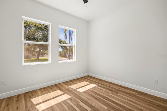 empty room featuring baseboards and wood finished floors
