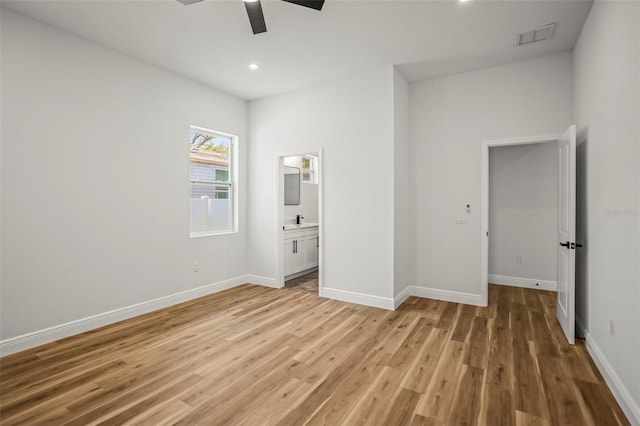 unfurnished bedroom featuring light wood-style floors, baseboards, connected bathroom, recessed lighting, and ceiling fan