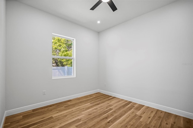 empty room featuring ceiling fan, baseboards, light wood-style flooring, and recessed lighting