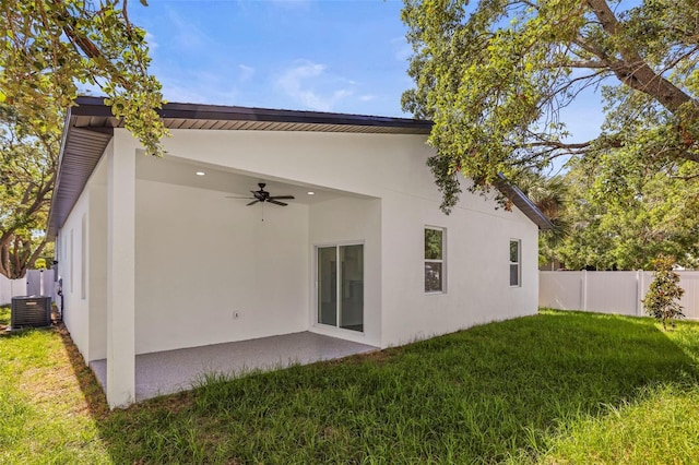 back of property featuring a ceiling fan, central AC unit, stucco siding, and a patio