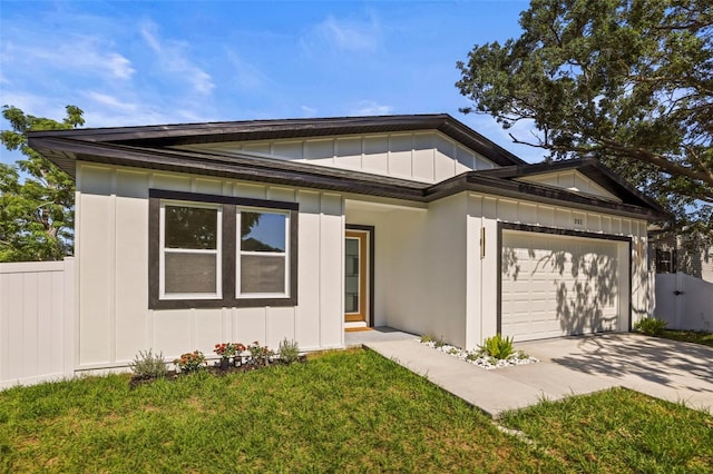 view of front of home with board and batten siding, a garage, and driveway