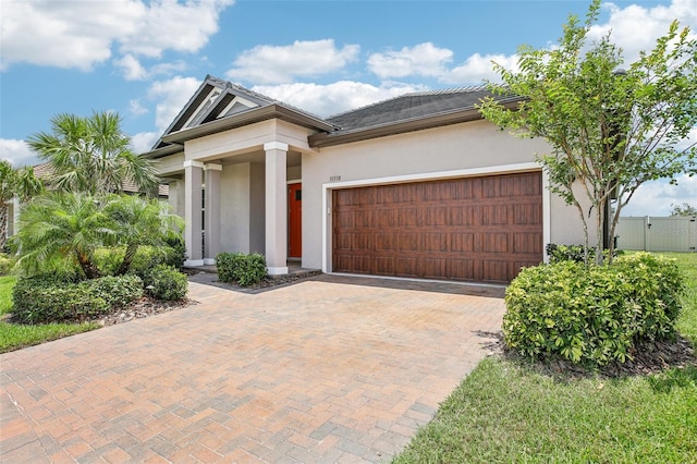 31510 Cabana Rye Ave, San Antonio, FL 33576 - view of front facade with stucco siding, an attached garage, and decorative driveway