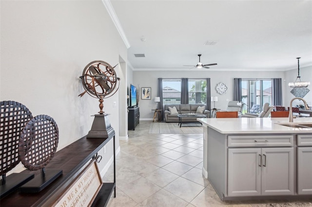 31510 Cabana Rye Ave, San Antonio, FL 33576 - kitchen featuring ornamental molding, gray cabinets, ceiling fan, pendant lighting, and light tile patterned flooring