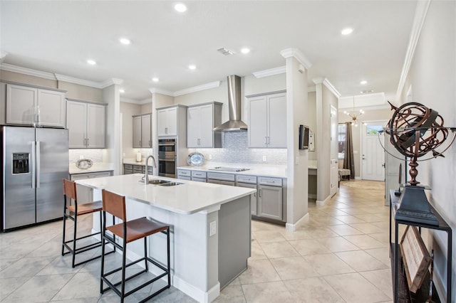 31510 Cabana Rye Ave, San Antonio, FL 33576 - kitchen with stainless steel appliances, wall chimney exhaust hood, gray cabinetry, a kitchen bar, and ornamental molding