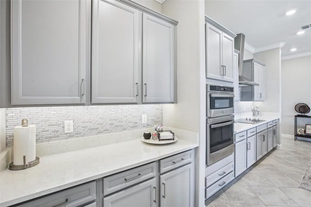 31510 Cabana Rye Ave, San Antonio, FL 33576 - kitchen with double oven, crown molding, tasteful backsplash, gray cabinets, and light countertops