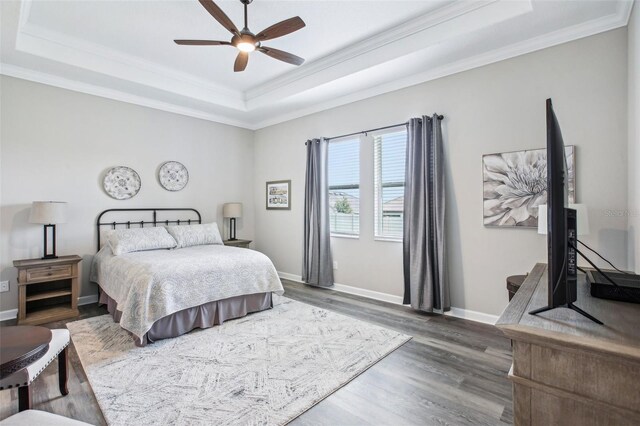 31510 Cabana Rye Ave, San Antonio, FL 33576 - bedroom featuring crown molding, a raised ceiling, wood finished floors, and a ceiling fan
