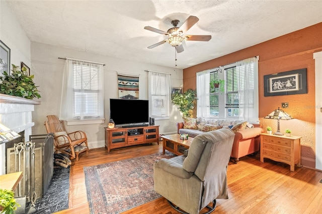 916 E Broad St, Tampa, FL 33604 - living area with healthy amount of natural light, light wood-type flooring, a ceiling fan, and a fireplace