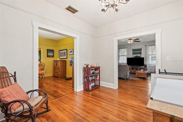 916 E Broad St, Tampa, FL 33604 - living area featuring light wood-style flooring, a chandelier, and baseboards