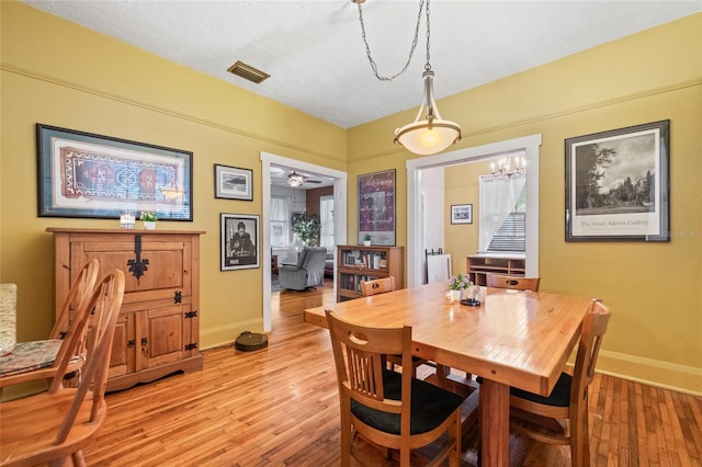 916 E Broad St, Tampa, FL 33604 - dining room with baseboards, light wood-style flooring, and a chandelier