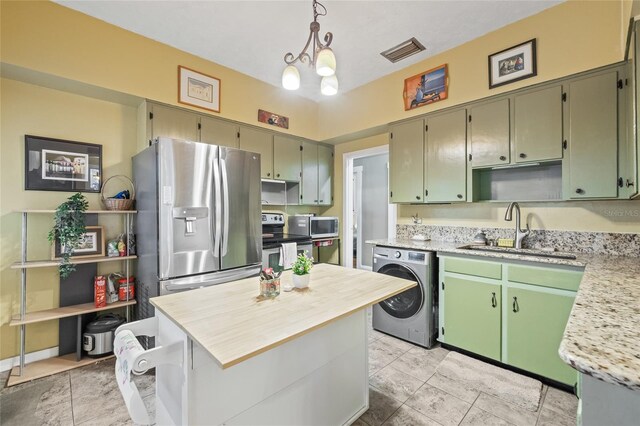 916 E Broad St, Tampa, FL 33604 - kitchen with washer / clothes dryer, a sink, stainless steel appliances, and open shelves