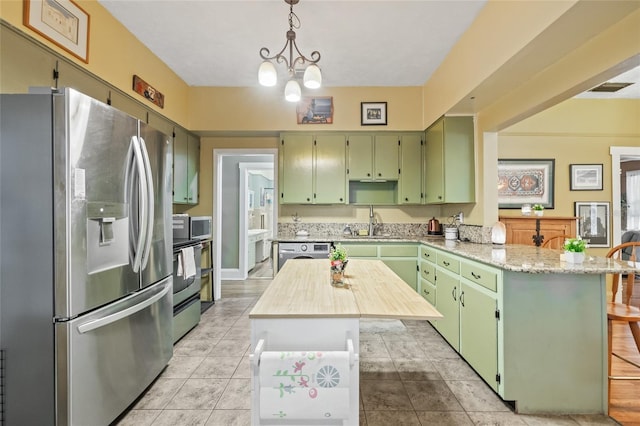 916 E Broad St, Tampa, FL 33604 - kitchen featuring appliances with stainless steel finishes, green cabinets, a peninsula, and a sink