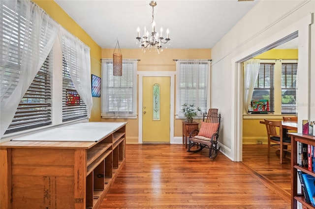 916 E Broad St, Tampa, FL 33604 - entryway with wood finished floors, a chandelier, and baseboards