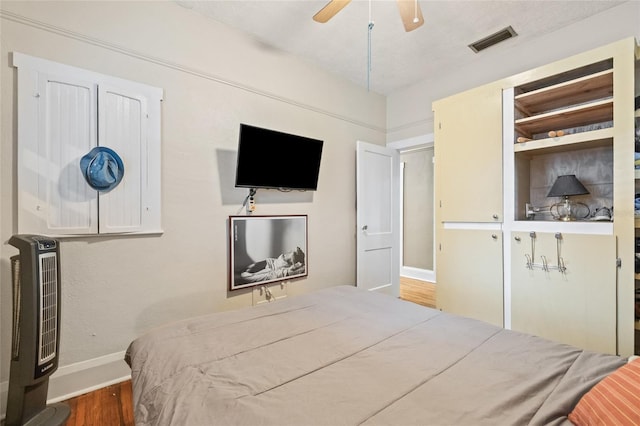 916 E Broad St, Tampa, FL 33604 - bedroom with baseboards, wood finished floors, heating unit, and ceiling fan