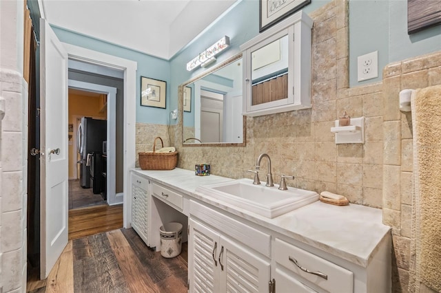 916 E Broad St, Tampa, FL 33604 - bathroom with wood finished floors, tile walls, and vanity