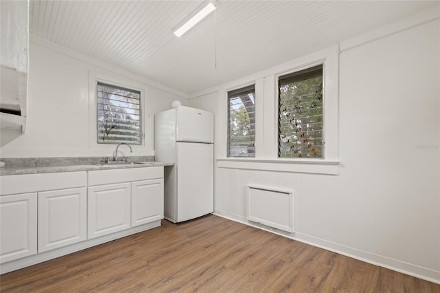 916 E Broad St, Tampa, FL 33604 - kitchen with freestanding refrigerator, a sink, white cabinetry, light countertops, and wood finished floors