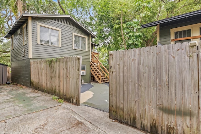 916 E Broad St, Tampa, FL 33604 - view of side of home with a patio area, fence, and stairs