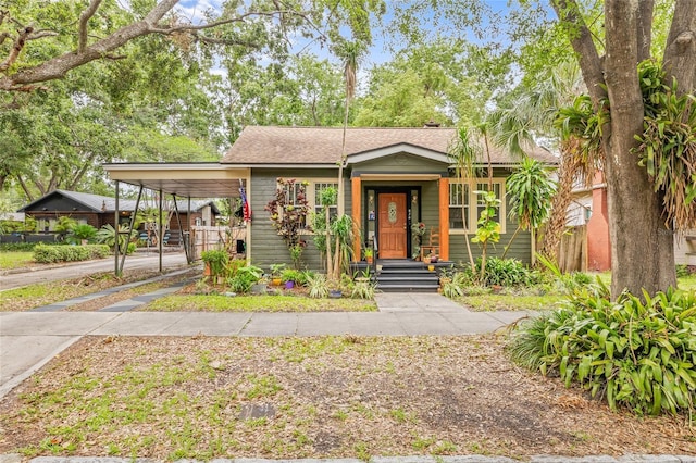 916 E Broad St, Tampa, FL 33604 - view of front of home featuring concrete driveway, a carport, and fence