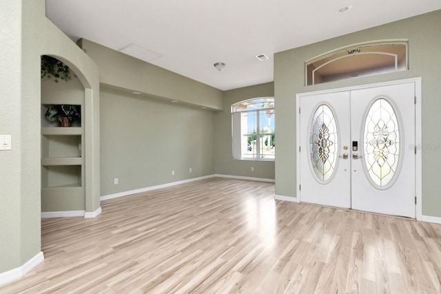 entrance foyer with light wood-style flooring and baseboards