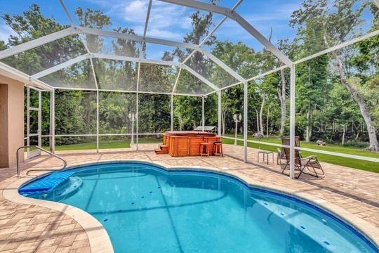 swimming pool featuring a patio and a lanai