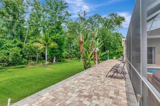 view of patio with a lanai