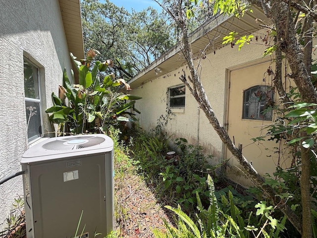 2995 N Bravo Dr, Beverly Hills, FL 34465 - view of home's exterior with cooling unit and stucco siding