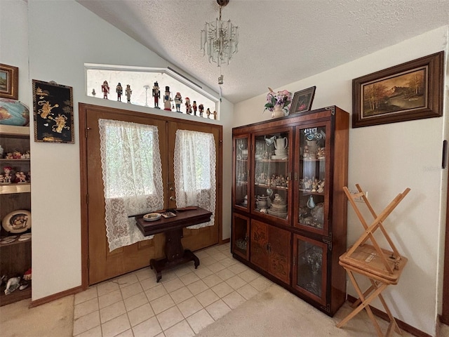 2995 N Bravo Dr, Beverly Hills, FL 34465 - entryway featuring a textured ceiling, lofted ceiling, french doors, light carpet, and baseboards