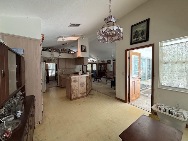2995 N Bravo Dr, Beverly Hills, FL 34465 - kitchen with plenty of natural light, lofted ceiling, a ceiling fan, a peninsula, and hanging light fixtures