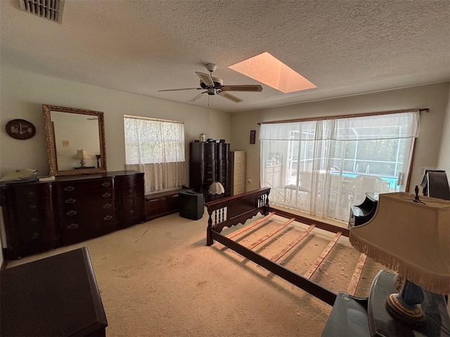 2995 N Bravo Dr, Beverly Hills, FL 34465 - carpeted bedroom featuring a skylight, a textured ceiling, and ceiling fan