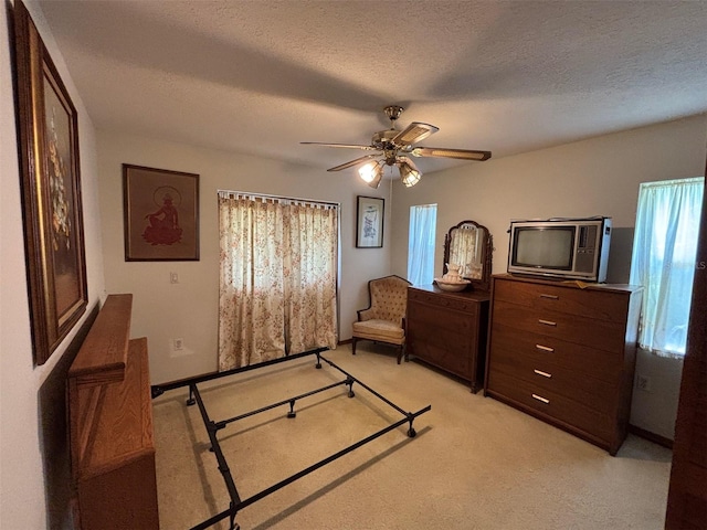 2995 N Bravo Dr, Beverly Hills, FL 34465 - bedroom featuring light carpet, a textured ceiling, and ceiling fan