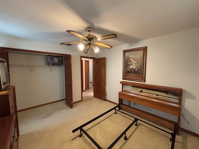 2995 N Bravo Dr, Beverly Hills, FL 34465 - bedroom featuring baseboards, a ceiling fan, light carpet, and a closet