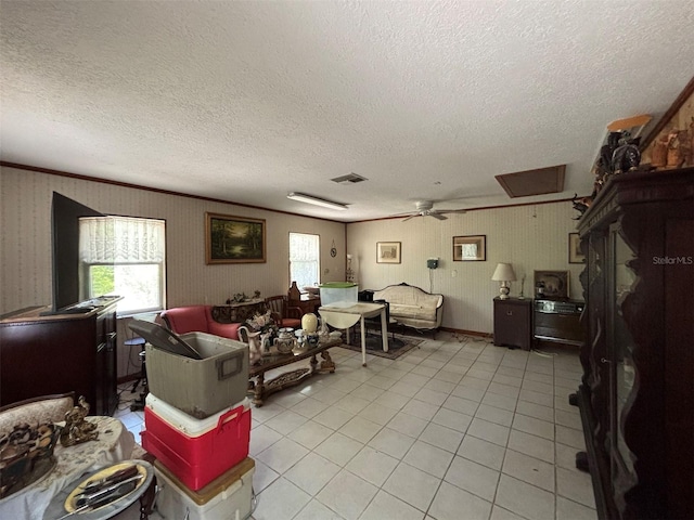 2995 N Bravo Dr, Beverly Hills, FL 34465 - living room featuring a textured ceiling, light tile patterned floors, ceiling fan, attic access, and ornamental molding