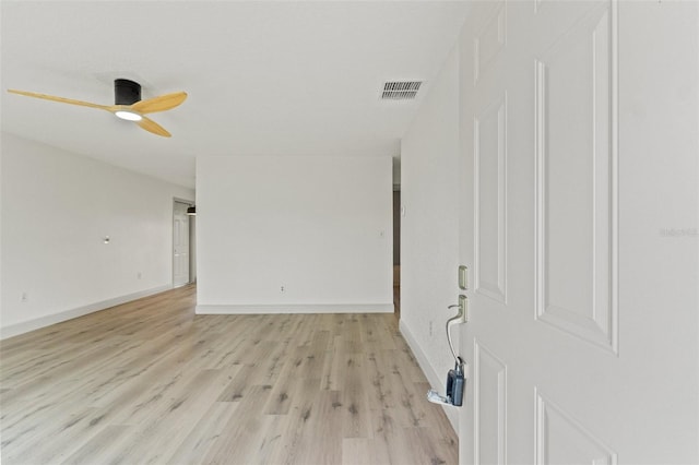 7400 Belvedere Ter, New Port Richey, FL 34655 - empty room with ceiling fan, light wood-style flooring, and baseboards