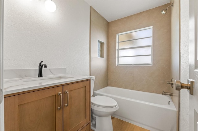 7400 Belvedere Ter, New Port Richey, FL 34655 - full bath featuring toilet, vanity, wood finished floors, shower / bathtub combination, and a textured wall