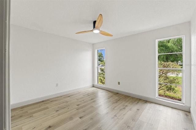 7400 Belvedere Ter, New Port Richey, FL 34655 - spare room featuring light wood finished floors, ceiling fan, and baseboards